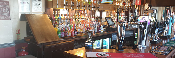 the Friar Tucks bar area with plenty of drinks and taps for beers and lagars